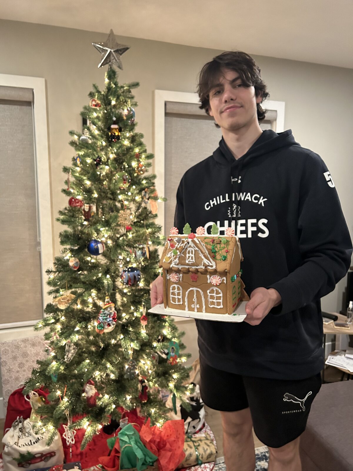 Nikitin builds his first gingerbread house with his billet family.